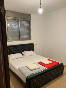 a bedroom with a bed with two towels on it at קסם המעיינות in Bet Sheʼan
