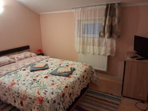 a bedroom with a bed with two towels on it at Cabana Vanatorului in Centru +19 photos