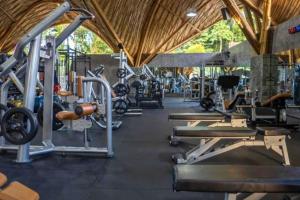 a gym with lots of equipment in a building at Bilha 1 BR Deluxe Suite Room in Kuta Lombok