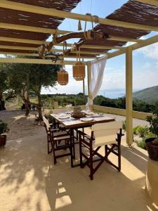 a table and chairs on a patio with a view at Katerina's House in Volímai