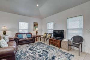 a living room with a couch and a flat screen tv at Molly's Place home in Crystal Beach
