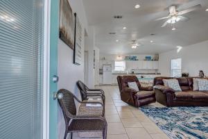 a living room with a couch and chairs and a kitchen at Molly's Place home in Crystal Beach