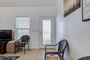 a living room with two chairs and a television at Molly's Place home in Crystal Beach +22 photos