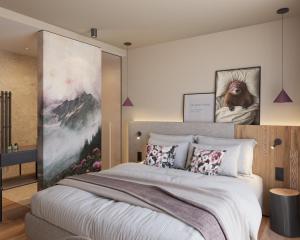 a bedroom with a large white bed with pillows at Ziach & Candy Grossarl in Grossarl