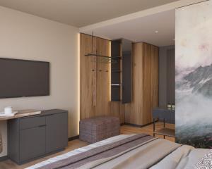 a bedroom with a bed and a tv on a wall at Ziach & Candy Grossarl in Grossarl