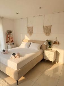 a bedroom with a large bed with two dolls on it at Basic Mansion Mandalina in Šibenik +24 photos