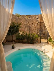 a large swimming pool in a yard with a building at Basic Mansion Mandalina in Šibenik