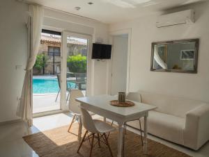 a living room with a table and a couch at Basic Mansion Mandalina in Šibenik