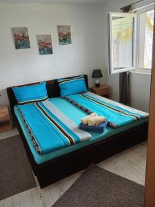 a large bed with blue sheets in a bedroom at Apartment Barbara in Kulen Vakuf