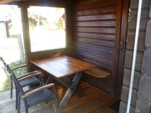 a wooden table and chairs in a room with a window at Ferienhaus Lauter 57 in Hayingen