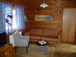 a living room with a couch and a table at Ferienhaus Lauter 57 in Hayingen +1 photo