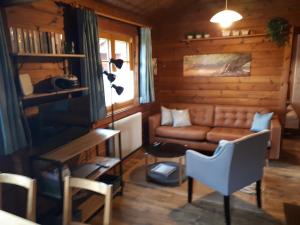 a living room with a couch and a table at Ferienhaus Lauter 57 in Hayingen
