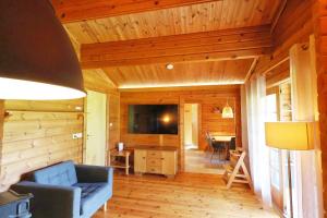 a living room with a blue couch and a television at Ferienhaus Neckar 46 in Hayingen
