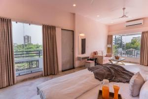 a bedroom with a large bed and a large window at Aara-boutique stay udaipur in Udaipur +67 photos