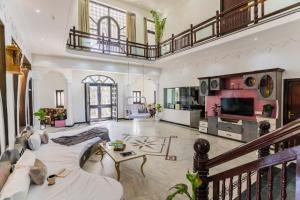 a large living room with a couch and a table at Aara-boutique stay udaipur in Udaipur