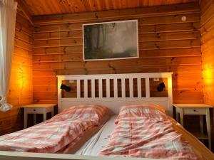 a bedroom with a bed in a wooden wall at Ferienhaus Neckar 43 in Hayingen