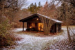 a small cabin in the woods in the snow at Ferienhaus Tauber 29 in Hayingen