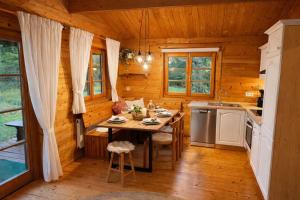 a kitchen with a table in a log cabin at Ferienhaus Tauber 29 in Hayingen