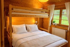 a bedroom with a bed in a wooden room at Ferienhaus Tauber 29 in Hayingen +1 photo