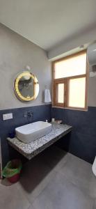 a bathroom with a sink and a mirror at Saathi Stay & Cafe in Vashisht +38 photos