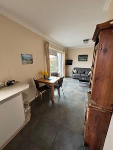 a living room with a table and a couch at Leuchtturm 1 in Fehmarn