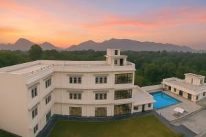 an aerial view of a building with a swimming pool at Serenity Hill Resort Near 2Km Fateh Sagar Lake Udaipur in Udaipur