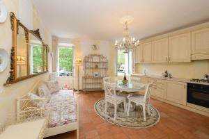 a kitchen with a table and chairs in a room at Relais De La Place - Downtown in Desenzano del Garda