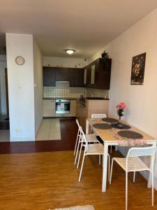 a kitchen and dining room with a table and chairs at Łucka 15 Sweet Home in Warsaw