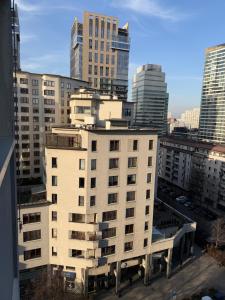 a white building in a city with tall buildings at Łucka 15 Sweet Home in Warsaw