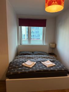 a bedroom with a bed with two towels on it at Łucka 15 Sweet Home in Warsaw +17 photos