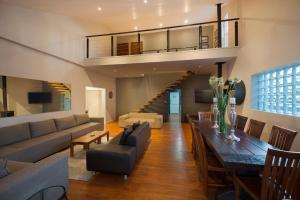a living room with a couch and a table at Tides End Manor House in Knysna