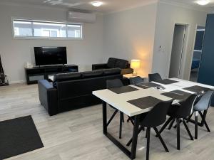 a living room with a table and a couch at Jurien Beachfront Chalets in Jurien Bay