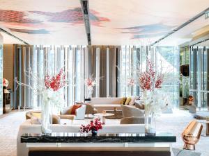 a living room with couches and flowers on the ceiling at Hilton Sukhumvit Bangkok in Bangkok
