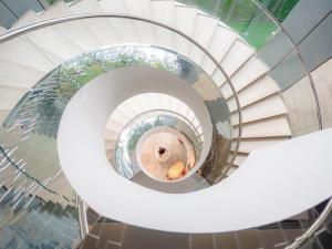 a spiral staircase with a person in the middle at Hilton Sukhumvit Bangkok in Bangkok +101 photos