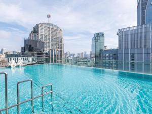 a large swimming pool on top of a building at Hilton Sukhumvit Bangkok in Bangkok