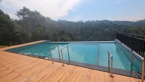a swimming pool on the deck of a house at Green Cove Munnar in Anachal