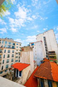 a view of two tall buildings and a red roof at Dreamora Signature Hotel in Hanoi