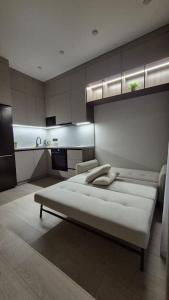 a bedroom with two beds and a kitchen at Umayahouses ЖК Орбита in Karagandy