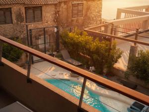 a balcony with a hot tub in a yard at BASIC MANSION plus with swimming pool & free parking in Šibenik