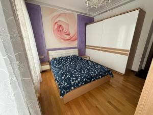 a bedroom with a bed and a painting on the wall at Premium Airport Residence 2 in Baku