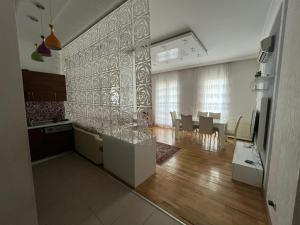 a kitchen and dining room with a table and a dining room at Premium Airport Residence 2 in Baku