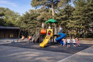 a group of children playing on a playground at Premium Airport Residence 2 in Baku