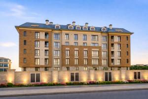 a large brick building with lights on it at Premium Airport Residence 2 in Baku