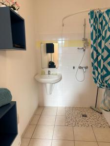 a bathroom with a sink and a shower at Studio Soulac centre et plage in Soulac-sur-Mer +13 photos