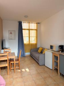 a living room with a couch and a table at Studio Soulac centre et plage in Soulac-sur-Mer