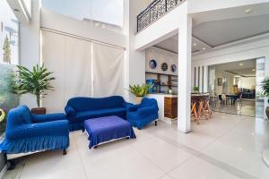 a lobby with blue chairs and a table at Palette Muine Boutique Hotel Near Mui Ne Beach in Mui Ne