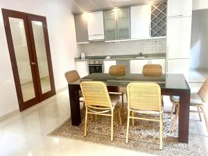 a kitchen with a dining room table and chairs at Peninsula Villa in Nusa Dua