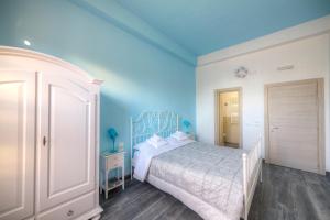 1 dormitorio con cama y pared azul en Il Viaggiator Leggero, en Florencia