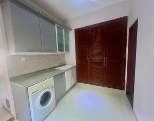 a laundry room with a washing machine and a sink at Peninsula Villa in Nusa Dua
