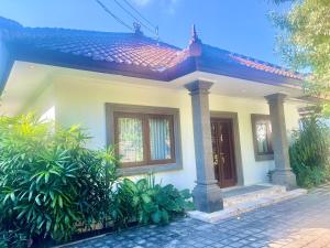 a small white house with a red roof at Peninsula Villa in Nusa Dua